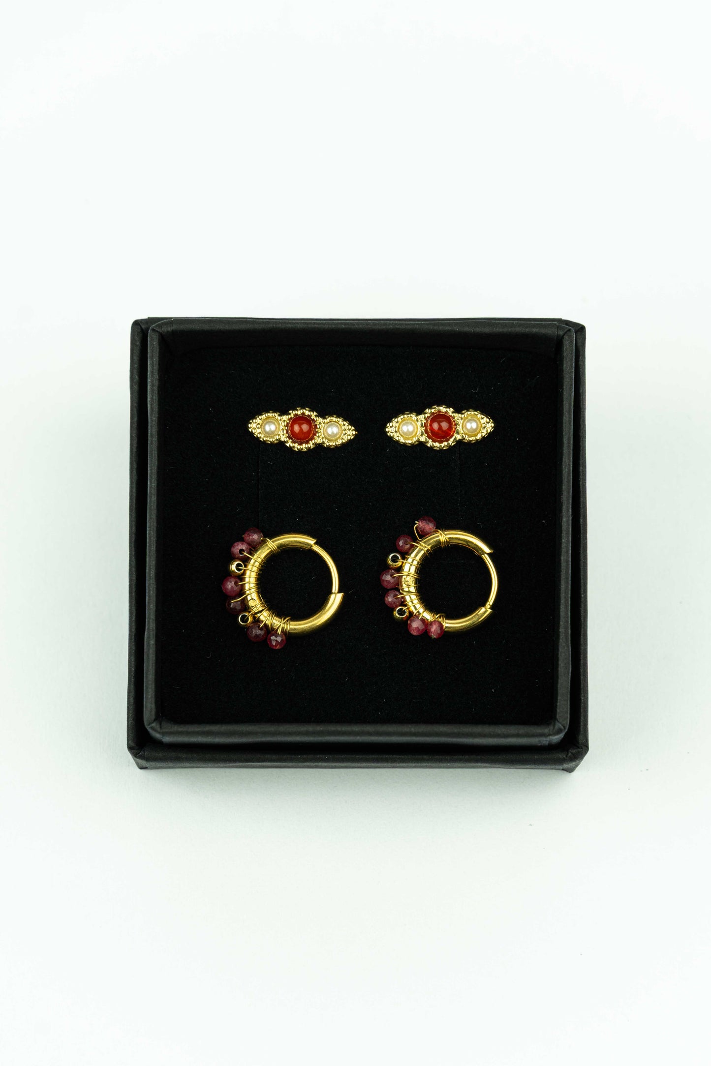 Beautiful set of 4 earrings.&nbsp;

A pair of creole hoops finished with tiny little Carnelian beads.&nbsp;&nbsp;

A pair of beautiful little studs with matching crystal.

The earrings are made out of stainless steel and handmade in our Stay Gold Antwerp atelier in the center of the city, just next to the cathedral of Antwerp.